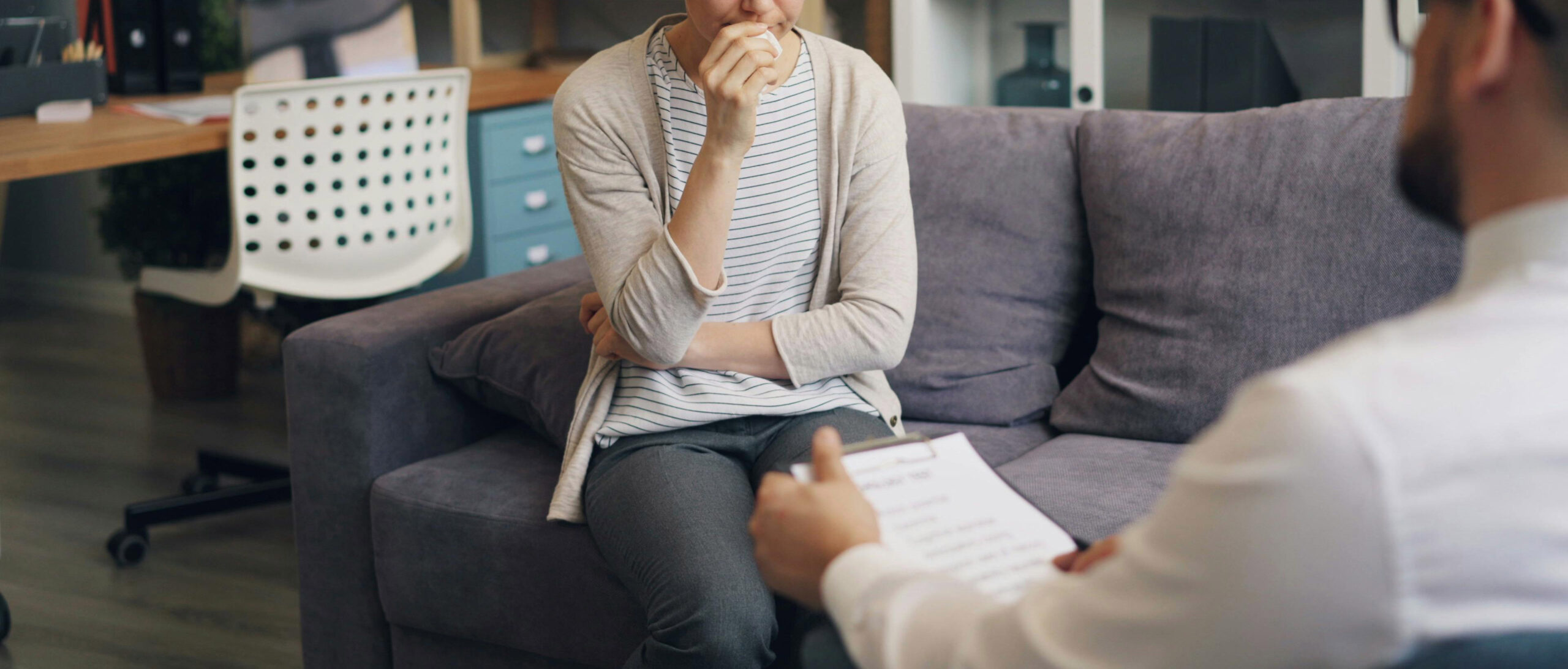 male therapist sits with client